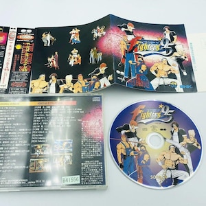 May include: The King of Fighters '95 video game soundtrack CD with a blue and white CD case and a blue and white CD with the text 'The King of Fighters '95' on it.