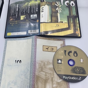 May include: A PlayStation 2 video game case and disc for "ICO." The case features artwork of a boy and girl, with Japanese text. The disc is gold with the game title and PlayStation 2 logo. Includes a booklet with illustrations.