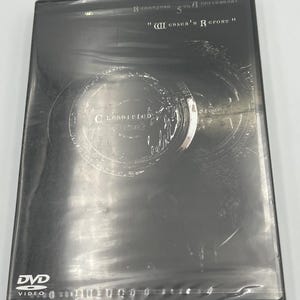 May include: A black Biohazard 5th Anniversary DVD case titled Wesker's Report. The cover features a dark, circular graphic with the word Classified printed in the center. The DVD Video logo is visible in the bottom left corner of the case.