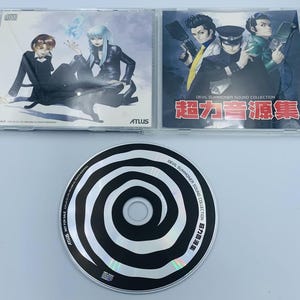 May include: Three compact discs featuring artwork from the "Devil Summoner Sound Collection." The CD cases display illustrations of anime characters. One CD has a black and white spiral design. The text "Devil Summoner Sound Collection" is visible.