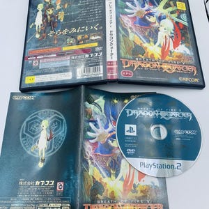 May include: A PlayStation 2 video game case and disc for "Breath of Fire V: Dragon Quarter." The case features colorful anime-style artwork and Japanese text. The disc is silver with blue text and the game's title. The case is open, revealing the game's manual.