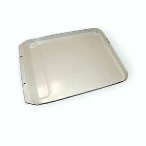 May include: White enamel baking tray with a raised edge and a small lip on one side. The tray has four small holes on the sides.