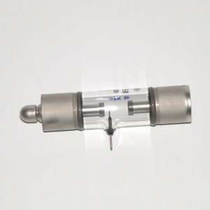 May include: A silver and glass vacuum tube with two metal pins and the text "30 KT 0" printed on the side.