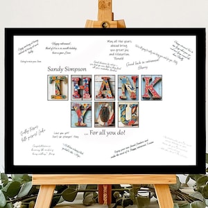 May include: A white framed sign with a black background and a colorful "Thank You" sign made of tiles. The sign is on a wooden easel and has handwritten messages on it. The sign says "Sandy Simpson Thank You ... For all you do!"