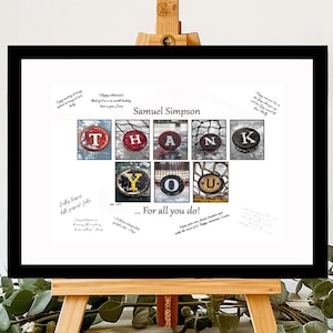 May include: A black framed print with a white background. The print features a hockey puck mosaic spelling "THANK YOU" with the name "Samuel Simpson" at the top. The print is on an easel and there is a black marker on a wooden surface.