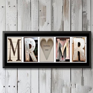 May include: A framed print with the letters "MR" in vintage metal letters, a heart with the text "Established 2021", and the letters "MR" again in vintage metal letters.