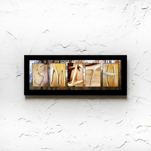 May include: A framed print of the name "SMITH" spelled out using antlers. The background is a blurred image of a forest.