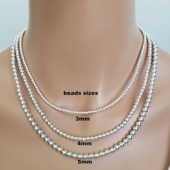 18-Inch Rhodium Plated Necklace with 4mm Light Amethyst Birthstone Beads and Sterling Silver Saint Joachim Charm.