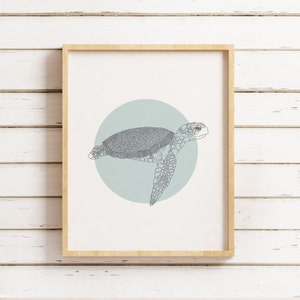 May include: A framed print of a line drawing of a sea turtle swimming in a light blue circle. The turtle is gray and has a detailed shell.