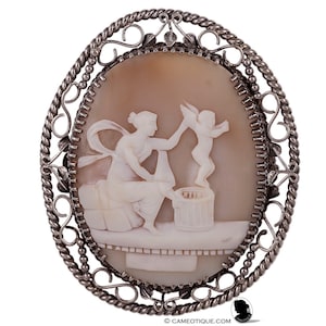 Shell cameo of maiden selling cherub in a solid silver mount. FREE WORLDWIDE SHIPPING.