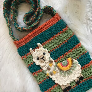 May include: A teal, green, and orange crocheted crossbody bag with a white crocheted llama applique. The llama has a rainbow-colored saddle and a fringe.