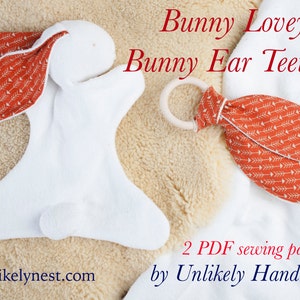 May include: Two PDF sewing patterns for a white bunny lovey and a matching orange and white bunny ear teether with arrow print. The patterns are by Unlikely Handmade and the website is unlikelynest.com.