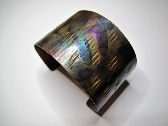 Copper Bracelet flame painted and hammered. The cuff is flame painted with a torch and covered by a protective coat