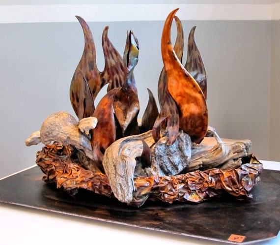 Copper sculpture and driftwood, The copper is colored with the blowtorch Made from copper sheets. Polyurethane finish.