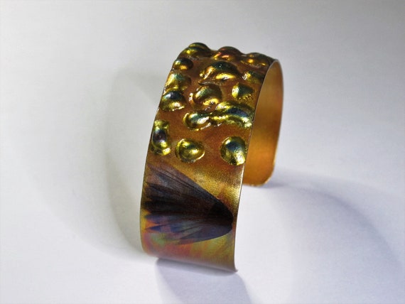 Copper Bracelet flame painted, yellow hue. The cuff is flame painted with a torch and covered by a protective coat, fire painting,