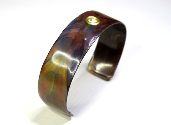 flame painted copper bracelet with Swarovski crystal inserted. The cuff is flame painted with a torch and covered by a protective coat
