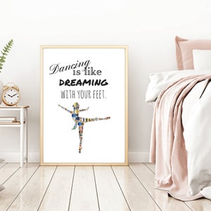 May include: A framed print with a white background and a black silhouette of a ballerina made of colourful shapes. The text "Dancing is like DREAMING WITH YOUR FEET." is printed in black below the ballerina.
