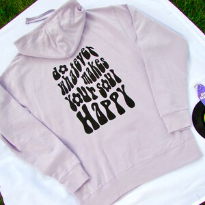 May include: A lavender colored hoodie with a black print on the back that says "do whatever makes your soul happy" in a retro font.