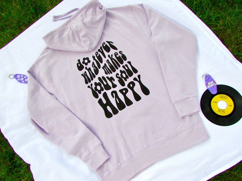 May include: A lavender colored hoodie with a black print on the back that says "do whatever makes your soul happy" in a retro font.