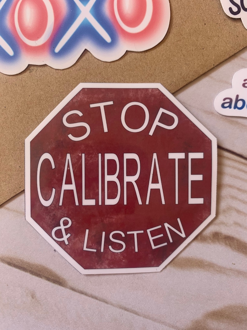 Op de afbeelding: Een rood achthoekig stopbord met witte tekst die "STOP CALIBRATE & LISTEN" luidt.