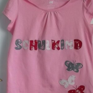 Shirt applique school child sews slings
