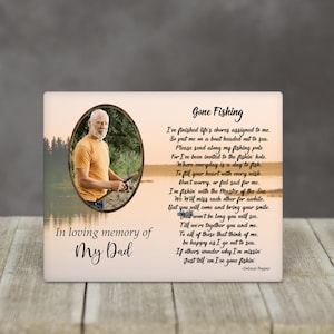 May include: A memorial plaque with a photo of a man fishing, surrounded by an oval frame. The text "Gone Fishing" and a poem are printed on the plaque, along with "In loving memory of My Dad."