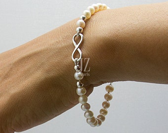 Freshwater Cultured Pearl infinity Bracelet featuring a  Sterling Silver Charm intertwined with Sterling Silver Beads and a S/S Magnet Clasp