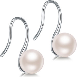 May include: A pair of silver dangle earrings with a white pearl on each earring.
