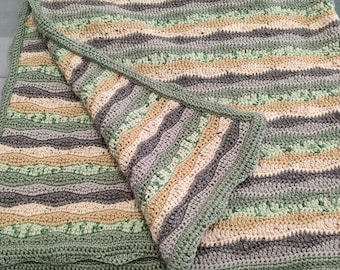 Warm, hand crocheted blanket in green, gray, and beige