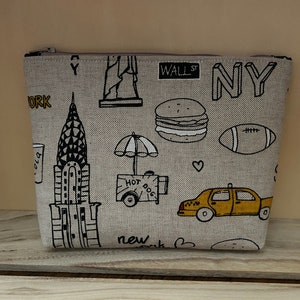 Borsa per il trucco/cosmetici fatta a mano in stile New York City. Tessuto effetto lino con chiusura a zip. Borsa da viaggio ideale per lei.