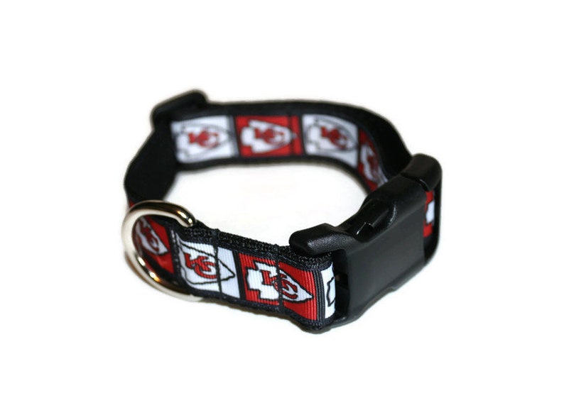 May include: Black dog collar with a red and white Kansas City Chiefs logo pattern.