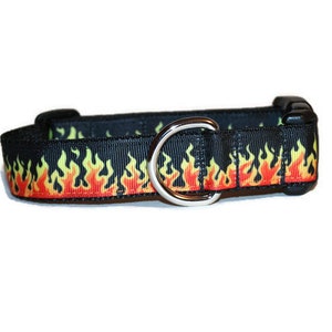 May include: Black dog collar with a yellow, orange, and red flame pattern.