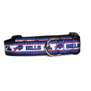 May include: A blue and white dog collar featuring the word "BILLS" and the team logo. The collar has a black buckle and a silver metal D-ring. The design includes red and white accents, perfect for showing team spirit.