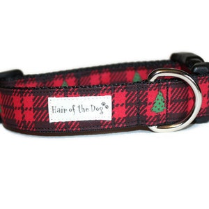 May include: Red and black plaid dog collar with green Christmas trees and the text "Hair of the Dog" on a white label.