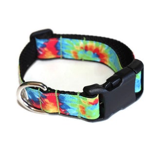 May include: A tie-dye dog collar with a black buckle and silver D-ring. The collar is made of a durable nylon material and features a colorful tie-dye pattern.