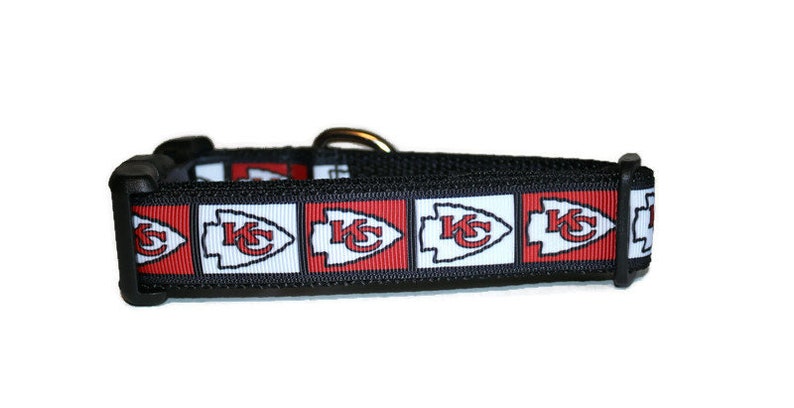 May include: Black dog collar with a red, white, and black pattern featuring the Kansas City Chiefs logo.