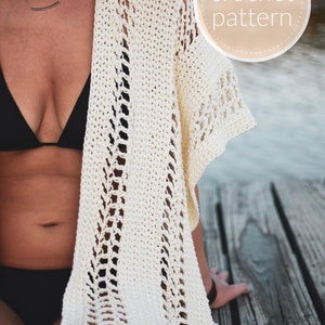 May include: A white crochet cover-up with a lacy pattern. The cover-up is worn over a black swimsuit. The image includes the text "crochet pattern".