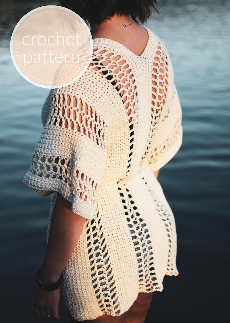 May include: A white crochet top with a lacy open back design. The top has a V-neck and short sleeves.