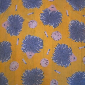 May include: A yellow fabric with a repeating pattern of blue and purple flowers. The flowers are stylized and have a whimsical look. The background is a solid yellow.