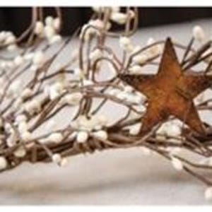 May include: A rustic wreath featuring a brown, weathered star and cream-colored berry clusters. The wreath is made of intertwined brown branches, creating a natural and decorative accent. Perfect for adding a touch of country charm to any space.