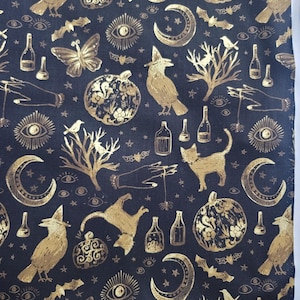 May include: Black fabric with a gold foil print of various Halloween-themed images, including cats, crows, moons, stars, pumpkins, and bottles.