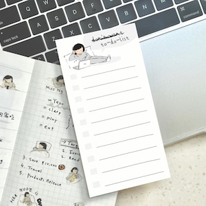 May include: A white to-do list with a black line border and a black and white illustration of a person sitting at a desk with a laptop. The text "don't want to-do-list" is written in black at the top of the list.