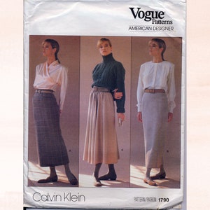 May include: Vogue Patterns American Designer sewing pattern for a skirt by Calvin Klein. The pattern number is 1790. The pattern shows three different styles of skirts: a plaid skirt, a beige skirt, and a grey skirt.