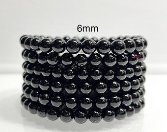 May include: A stack of black 6mm round beads.