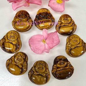 May include: Eight golden brown tiger's eye stone carvings of the laughing Buddha, each with a unique pattern and texture.