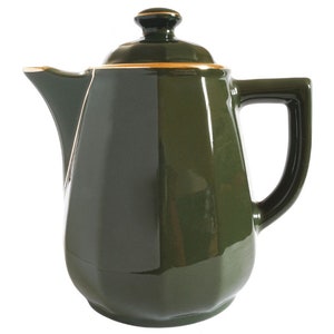 May include: A dark green ceramic teapot with a lid and a handle. The teapot has a gold trim around the lid and spout. The teapot is a classic design.
