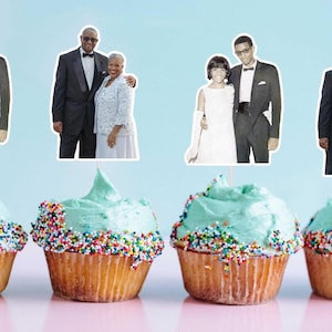 May include: Cupcakes with light blue frosting and colorful sprinkles, topped with vintage photo cutouts of couples. The cupcakes sit on a pink surface against a light blue background. The cupcakes are in brown paper liners.
