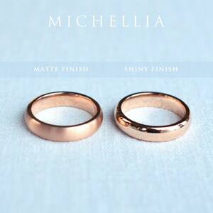 May include: Two rose gold wedding bands, one with a matte finish and the other with a shiny finish. The word "MICHELLIA" is at the top of the image. The text "MATTE FINISH" and "SHINY FINISH" are also visible.