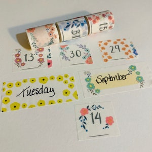 May include: Assortment of floral patterned washi tapes with numbers and text. The tapes include the numbers 13, 14, 15, 29, 30, 31, the word "September", and the word "Tuesday".