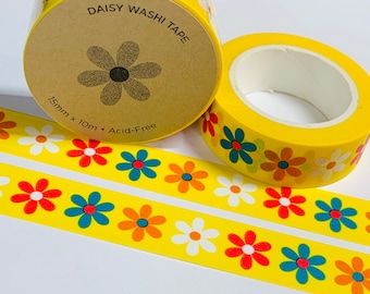May include: Two rolls of yellow washi tape with a daisy pattern. The tape is 15mm wide and 10m long. The tape is acid-free. "Daisy Washi Tape" is printed on the label.